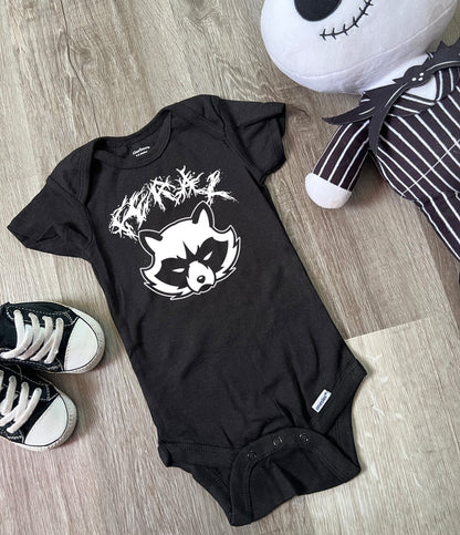 Black baby bodysuit with white metal band lettering saying feral. Cartoon angry raccoon under the word feral. 